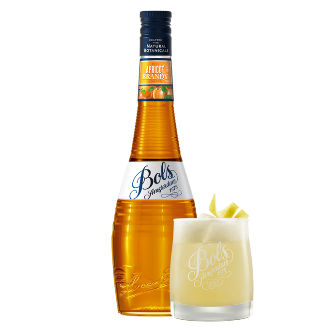 Bols Apricot Brandy bottle with a glass of apricot brandy cocktail on a white background