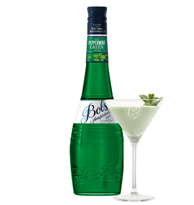 Green bottle of Bols Peppermint Green liqueur with a glass of the liqueur garnished with mint leaves on a white background.