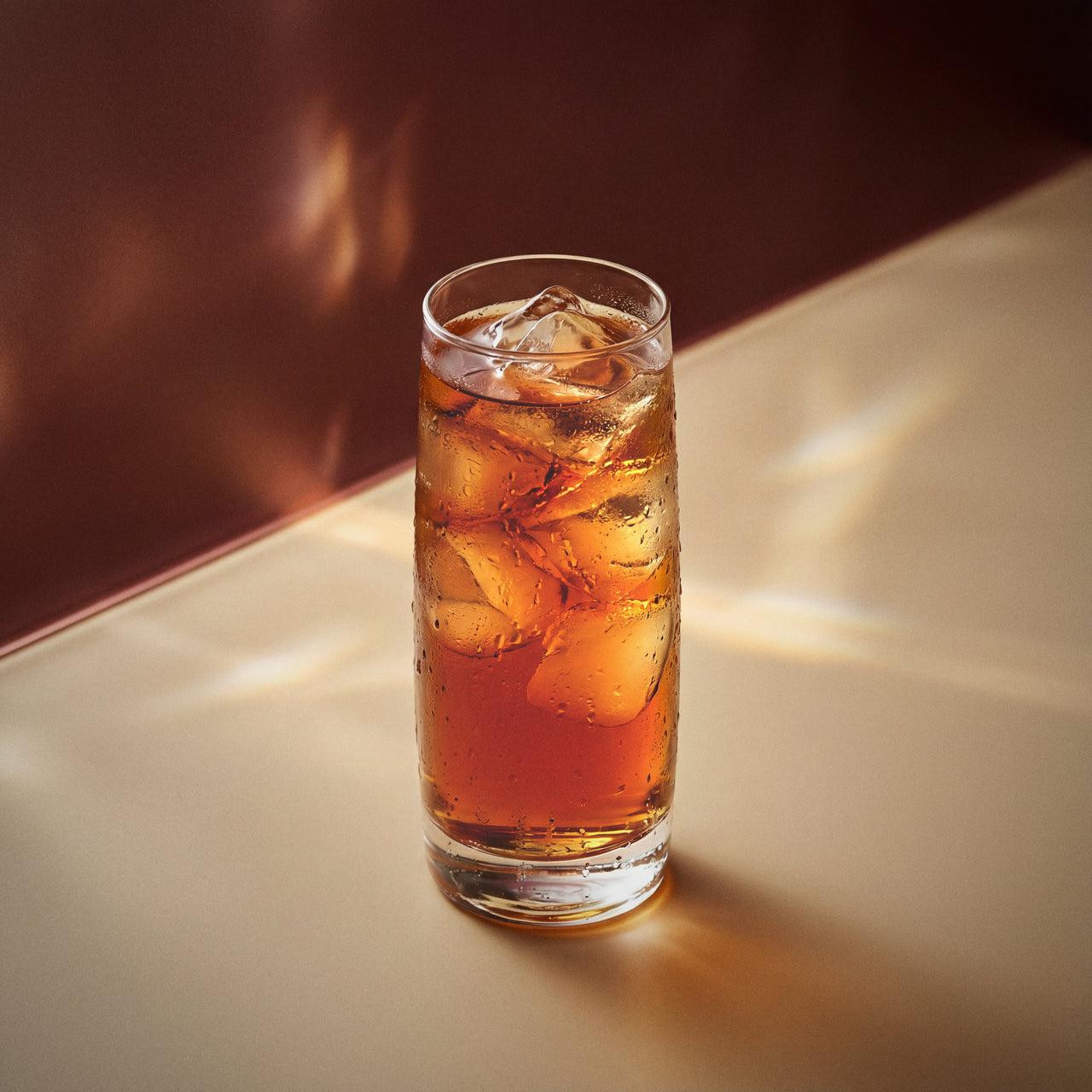 coffee easy mix cocktail with coffee liqueur in a highball glass on a textured surface